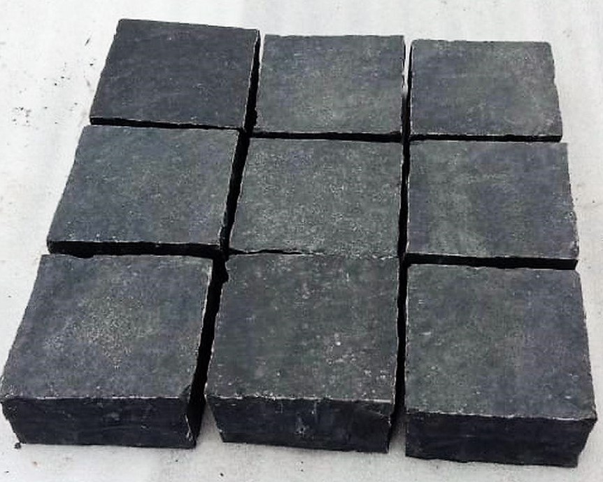 Black Limestone cobbles. Measuring 100mm x 100mm wide and 40mm - 60mm thickness. Price per cobble. THE BENEFITS OF USING BLACK LIMESTONE COBBLES FOR YOUR PROJECT When embarking on a project, one of the foremost basic decisions to be made is what building materials to use.  There is a lot of choice available when it comes to cobbles so lets look at some of the benefits of using black limestone cobbles. Cost Firstly when starting a new project, costs can be a major concern.  Using cobbles is an excellent choice for lowering expenditure on your project. These cobbles do not have any of the associated production costs attached to them that new materials do, allowing the prices to stay low. Environmentally friendly Secondly one of the largest advantages of using cobbles is that they are an environmentally friendly option. The construction industry in the UK is a huge contributor to national waste and carbon emissions. Such emissions can come from extracting, producing, manufacturing and transporting building materials. By using cobbles you can cut out a lot of this negative environmental impact as you are using pre-made materials, for instance. Adds character Thirdly using these materials for your project can be a fantastic way to add character and individuality. These materials can help create a unique finish, allowing you to make a truly original building. When used for paving, the variety of textures and tones available with cobbles are sure to create an attractive and eye catching finish.