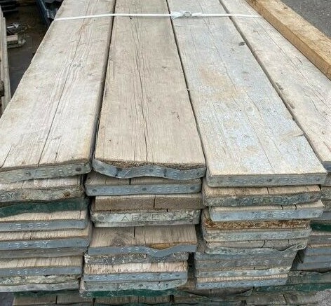 This is a picture of reclaimed scaffold boards. A reclaimed board is one which comes from stock used in actual scaffolding. Great for extra character and therefore tend to be what people are looking for when they're after that classic, rustic look. Newer boards are more uniform, clean, and therefore more sought after by makers, as they are suited to furniture and other similar uses.